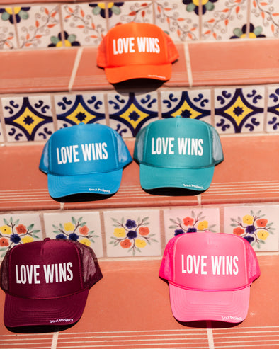 Love wins trucker hats.Love Wins trucker hat, hand printed in Laguna Beach CA at The Soul Project  100% Polyester Front, 100% Nylon Mesh Back 5-panel cap Plastic Adjustable Back Snap