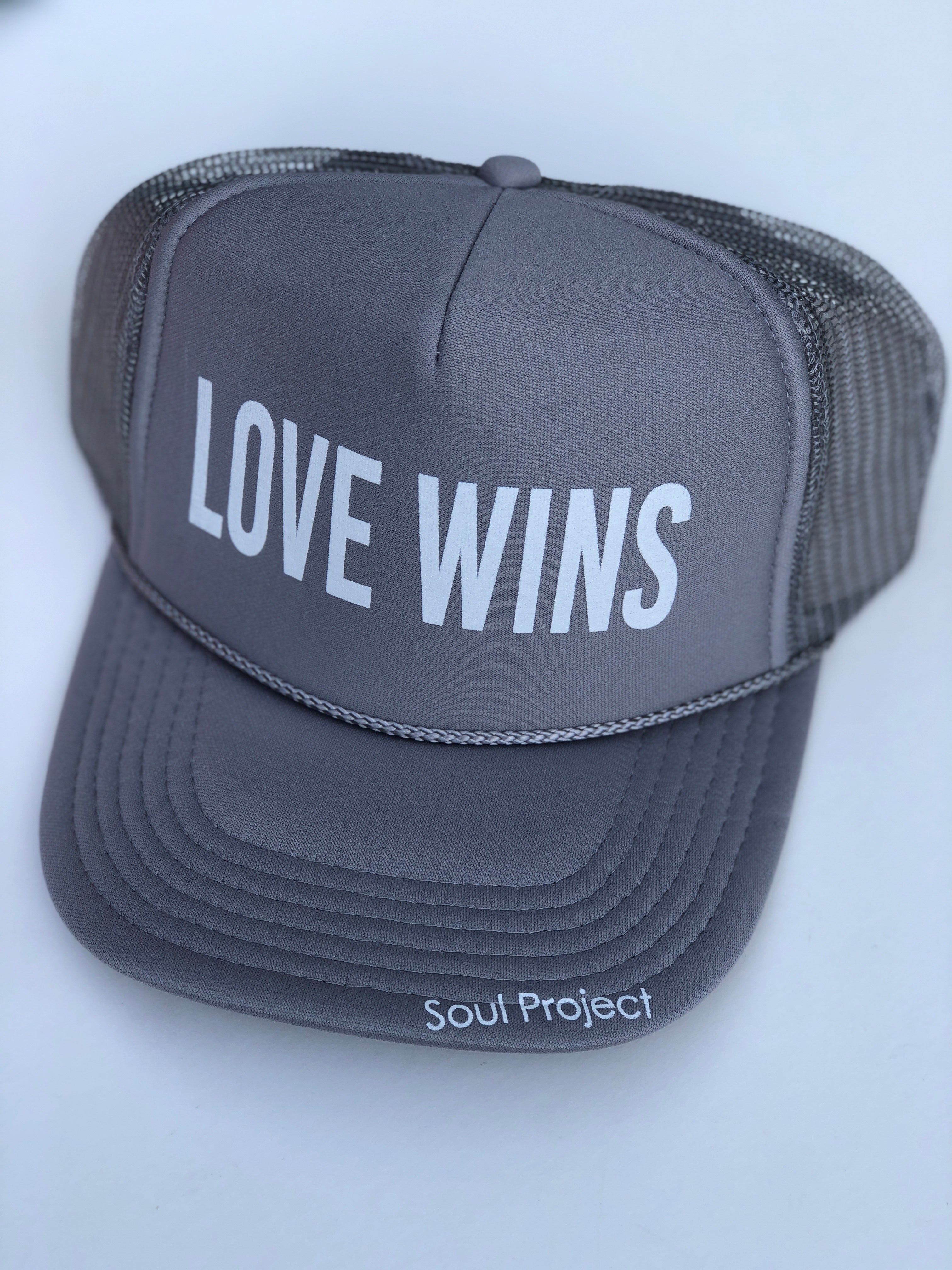 Love Wins trucker hat, hand printed in Laguna Beach CA at The Soul Project  100% Polyester Front, 100% Nylon Mesh Back 5-panel cap Plastic Adjustable Back Snap