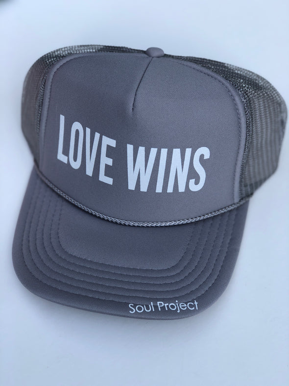 Love Wins trucker hat, hand printed in Laguna Beach CA at The Soul Project  100% Polyester Front, 100% Nylon Mesh Back 5-panel cap Plastic Adjustable Back Snap