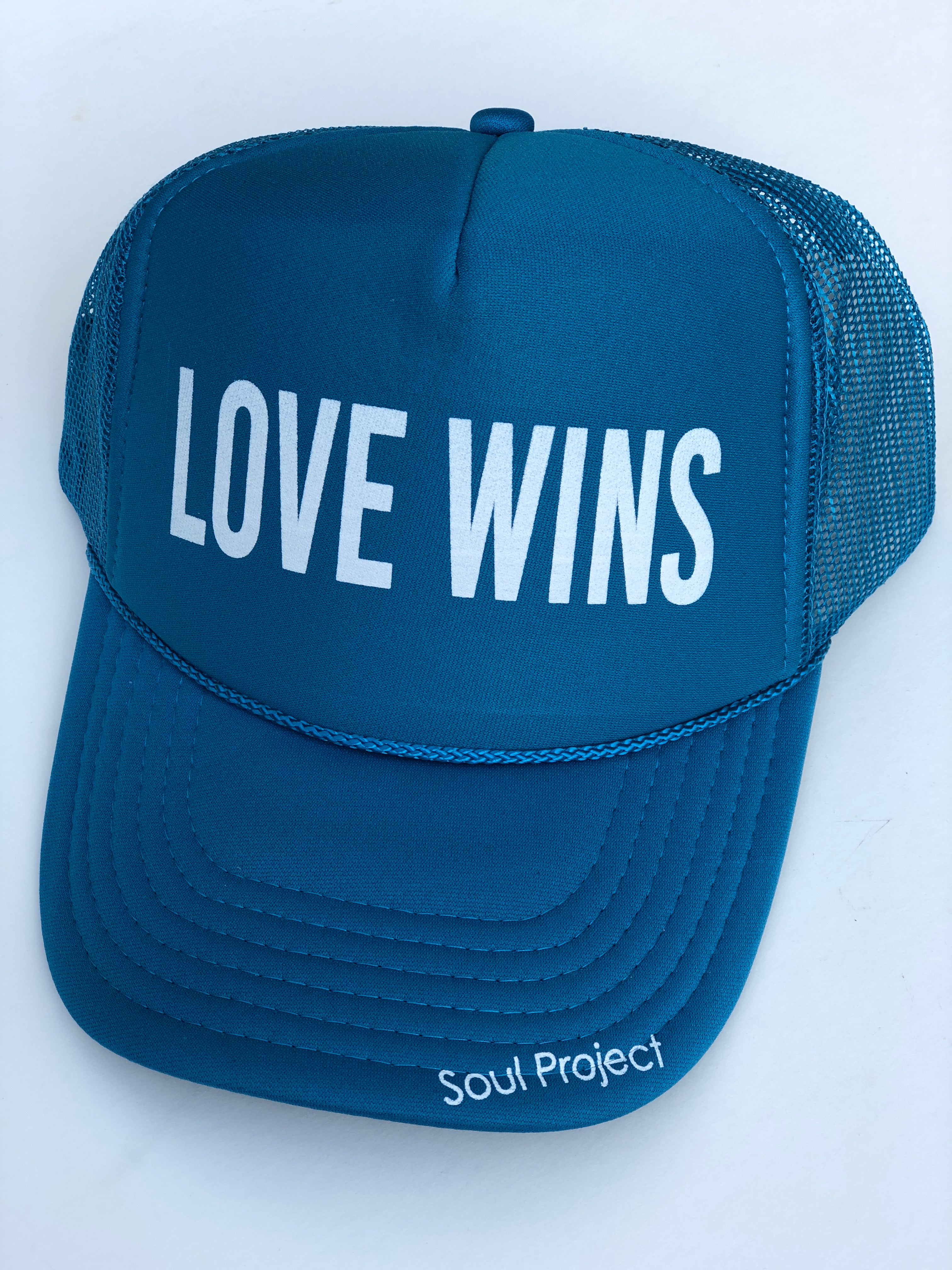 Love Wins trucker hat, hand printed in Laguna Beach CA at The Soul Project  100% Polyester Front, 100% Nylon Mesh Back 5-panel cap Plastic Adjustable Back Snap