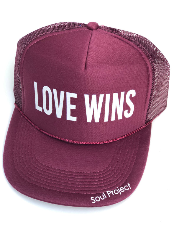 Love Wins trucker hat, hand printed in Laguna Beach CA at The Soul Project  100% Polyester Front, 100% Nylon Mesh Back 5-panel cap Plastic Adjustable Back Snap