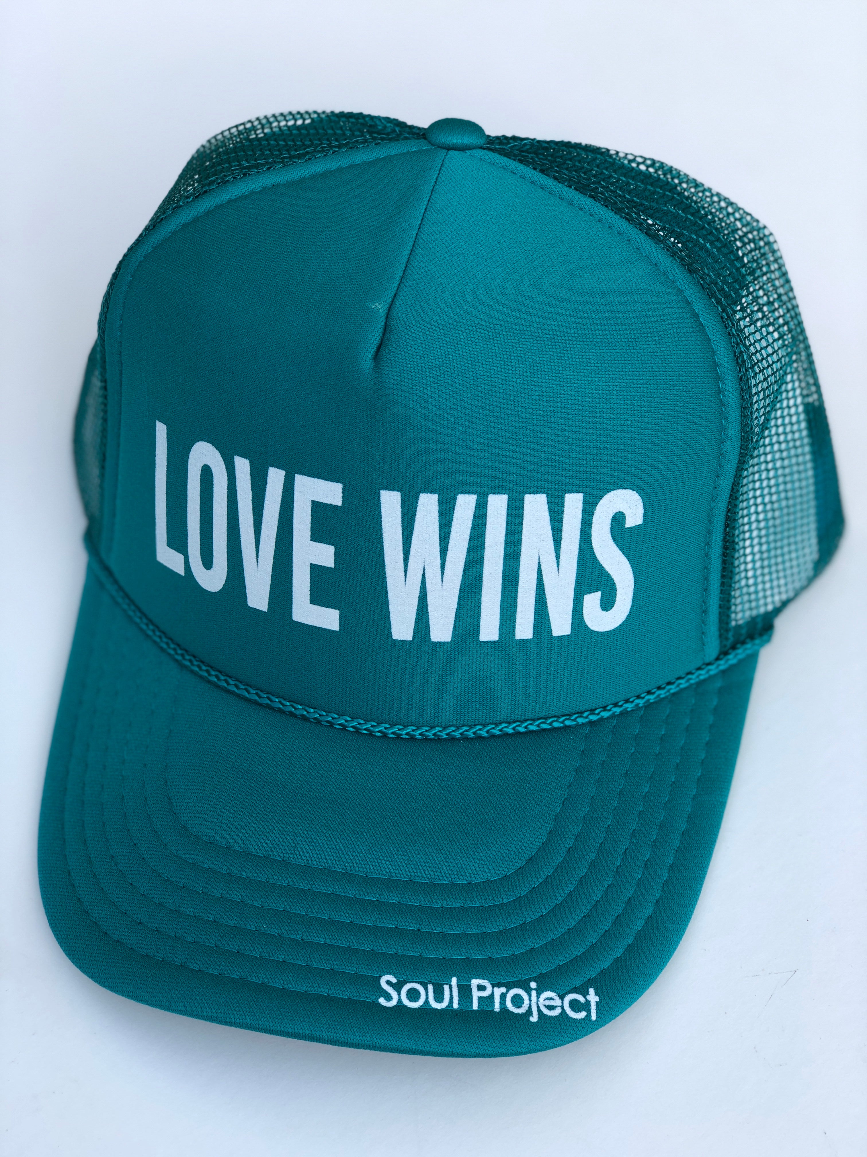 Love Wins trucker hat, hand printed in Laguna Beach CA at The Soul Project  100% Polyester Front, 100% Nylon Mesh Back 5-panel cap Plastic Adjustable Back Snap