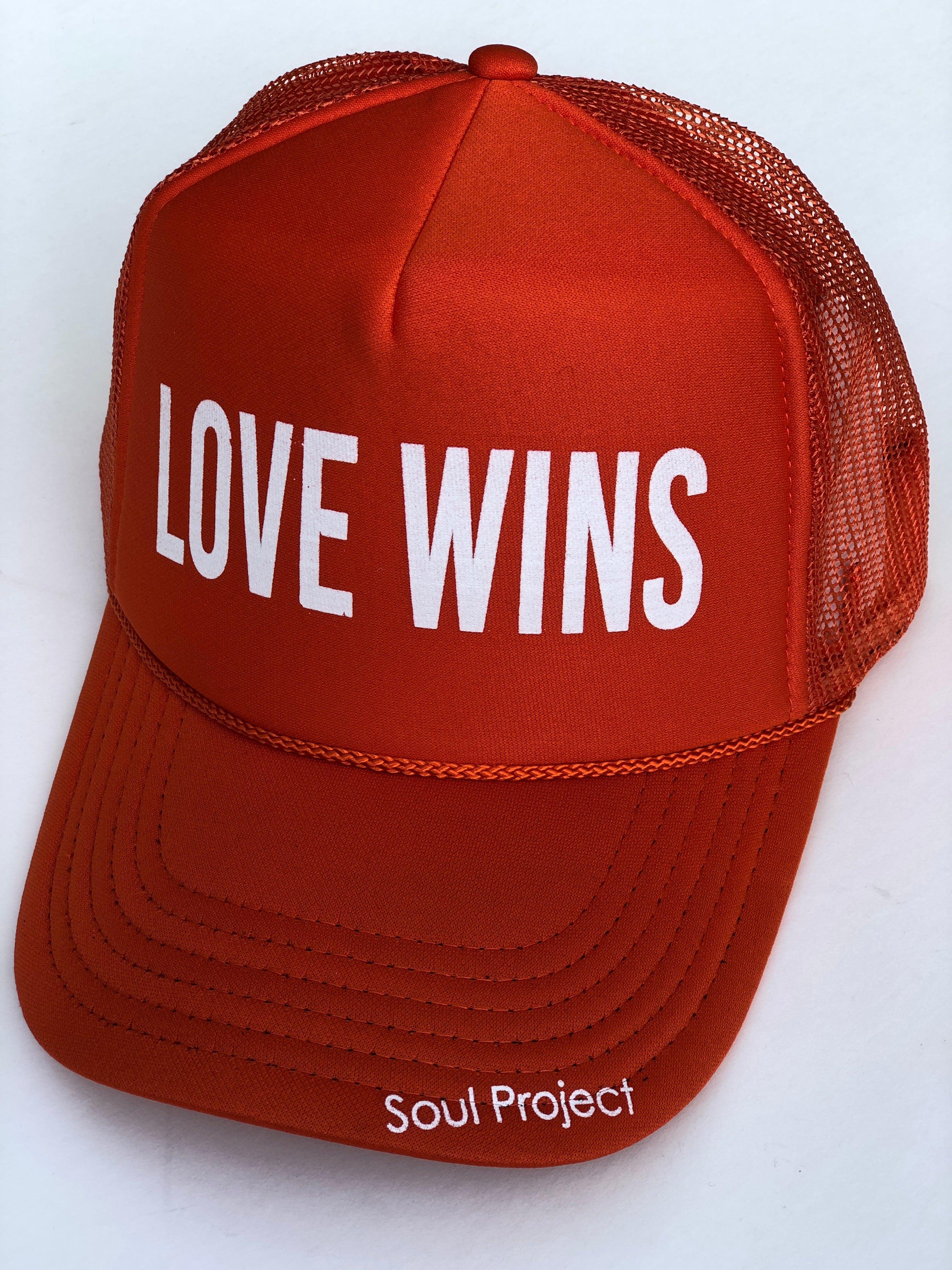 Love Wins trucker hat, hand printed in Laguna Beach CA at The Soul Project  100% Polyester Front, 100% Nylon Mesh Back 5-panel cap Plastic Adjustable Back Snap